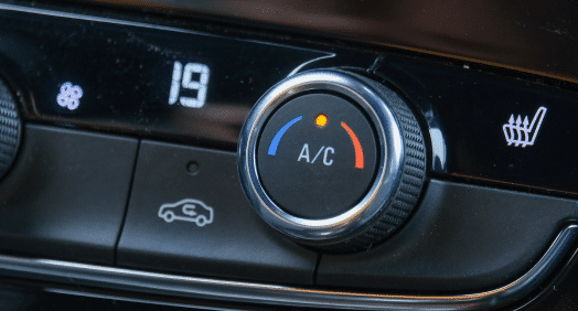 Auto Air Conditioning and Heating Services in Franklin, MA at Advanced European Repair. Image of a car's air conditioning control panel with the AC button highlighted, emphasizing our expertise in providing comprehensive auto AC and heating services.