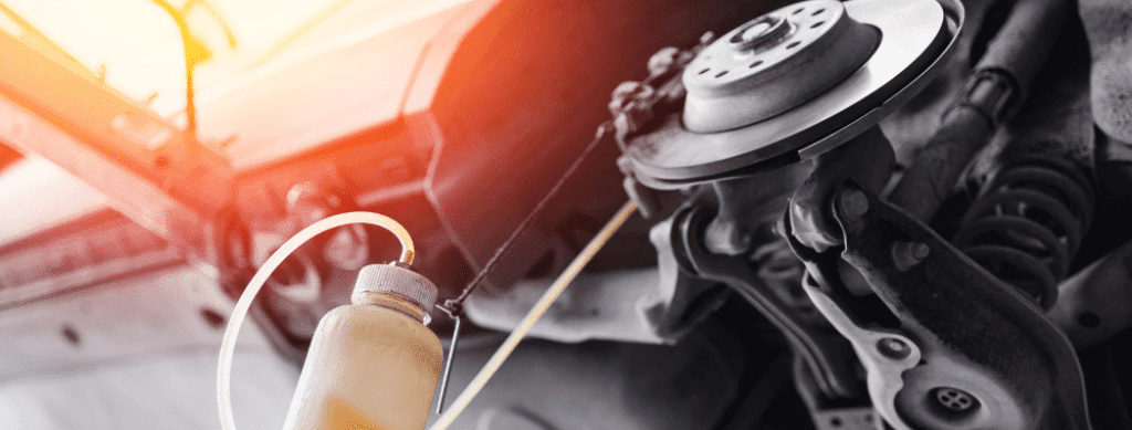 brake fluid flush, European auto repair in Franklin, MA at Advanced European Repair. Brake fluid being extracted from a car's braking system during a service.