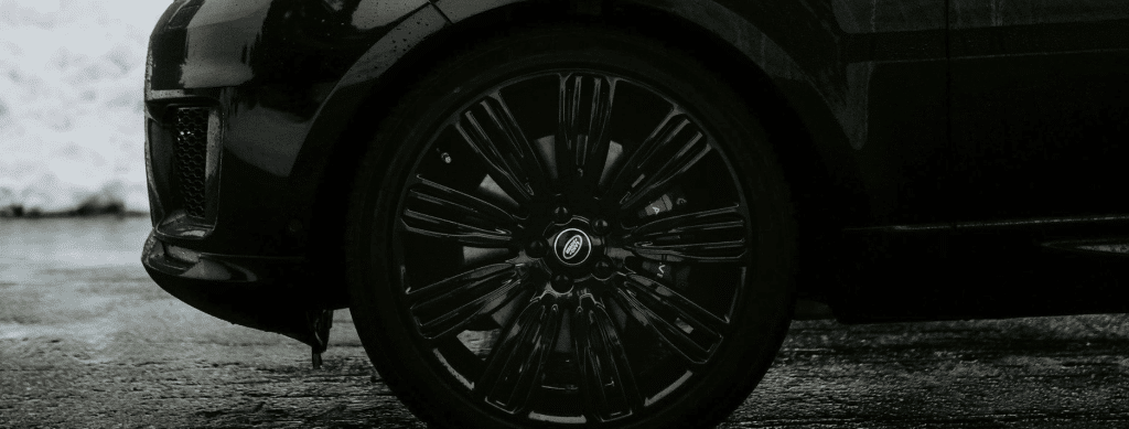 Land Rover brake fluid flush in Franklin, MA by Advanced European Repair. Image showing a close-up of a Land Rover wheel with black alloy rims and red brake calipers, emphasizing precision tire and brake maintenance for European vehicles.