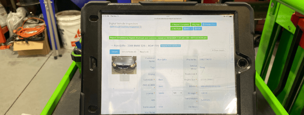 Digital vehicle inspections in Franklin, MA by Advanced European Repair. A tablet displays detailed inspection data for a 2009 BMW 328i, showcasing the use of technology for accurate diagnostics and vehicle report generation.