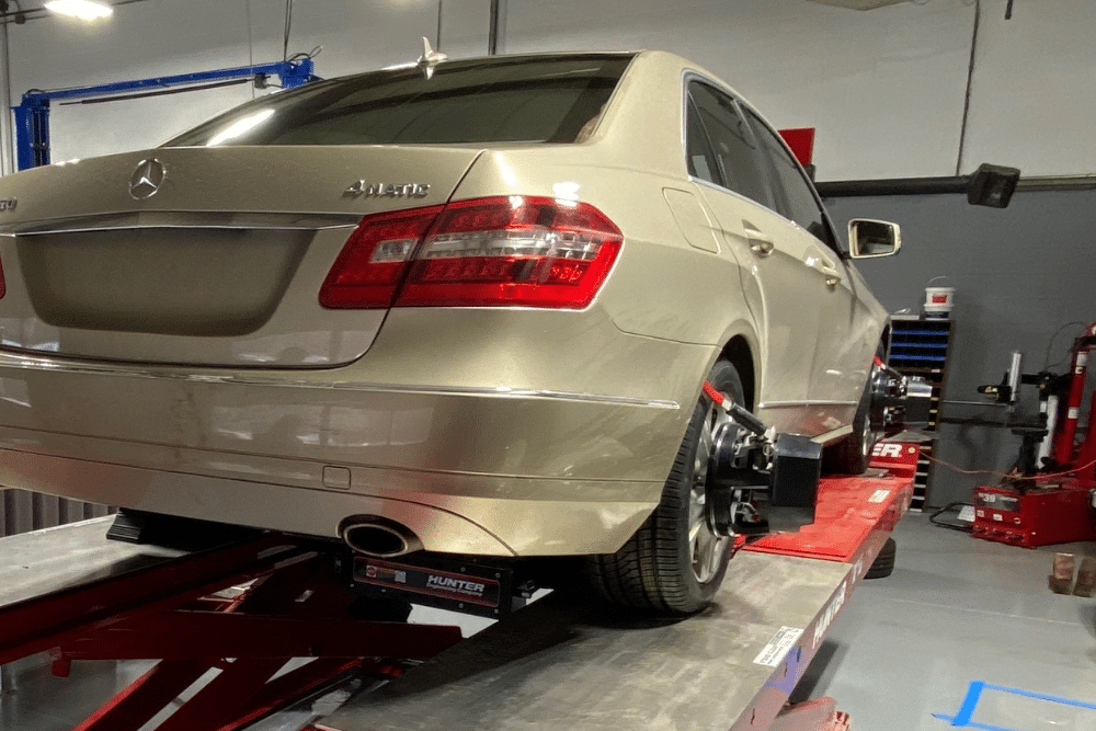 European Wheel Alignment in Franklin, MA At Advanced European Repair. Image of Mercedes-Benz sedan mounted on a Hunter wheel alignment rack